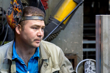 Wall Mural - Close-up portrait of a welder in the workplace