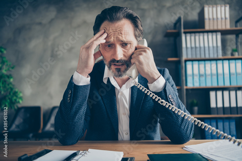 Close-up portrait of his he depressed miserable jobless middle-aged guy employee talking on phone failure crisis staff reduction at modern loft industrial style interior workplace workstation