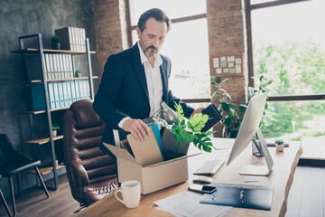 Profile photo of upset fired worker mature aged guy laid off manager loser lost job work pack belongings carton staff box leaving office financial crisis crash table desktop indoors