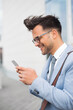 © Jelena - Wealthy young businessman using cellphone