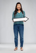 © Syda Productions - direction and people concept - happy smiling asian young woman holding big white rightwards thick arrow over grey background