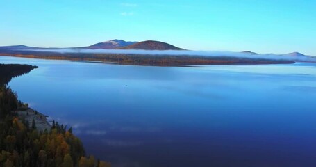 Wall Mural - Aerial video of beautiful mountain lake on a frosty autumn morning.