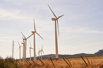 Wind turbine line producing electricity in the field. Concept of renewable energies. Cadiz, Spain.