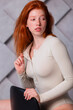 © oleg_ermak - Young caucasian woman posing in studio in bodysuit. Redhead model with healthy freckled skin. Home comfort in lingerie