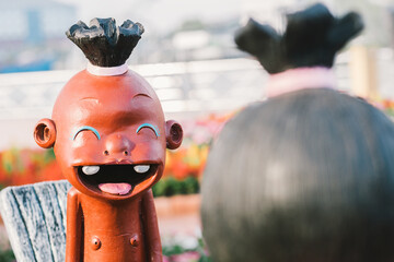 Laughly child face of Clay Doll, Thai Clay Doll