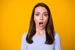 Closeup photo of attractive pretty shocked speechless lady open mouth look on camera terrified eyes listen bad awful news wear casual shirt isolated vibrant yellow color background