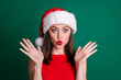Clsoeup photo of attractive charming funky lady send air kisses raise arms funny facial expression coquettish person wear red snow girl dress fluffy santa cap isolated green color background