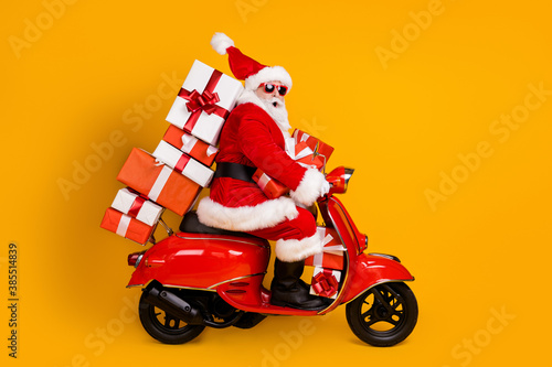 Fotomural Profile side view of his he nice funny cheery amazed St Nicholas riding moped hu