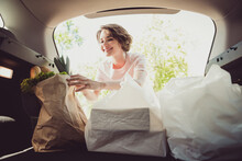 Photo Of Girl Shopper Put Shopping Bags In Car Trunk Cabin Ready Ride Drive Home Cook Family Husband Meal In Town Center Outside