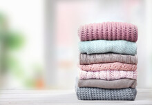 Stack Of Knitted Textured Clothing On Table.Colorful Winter Clothes,warm Apparel.Heap Of Knitwear.