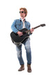 © sharplaninac - Man guitarist musician paying acoustic guitar with skill and passion wearing jeans. Full body isolated on white background.