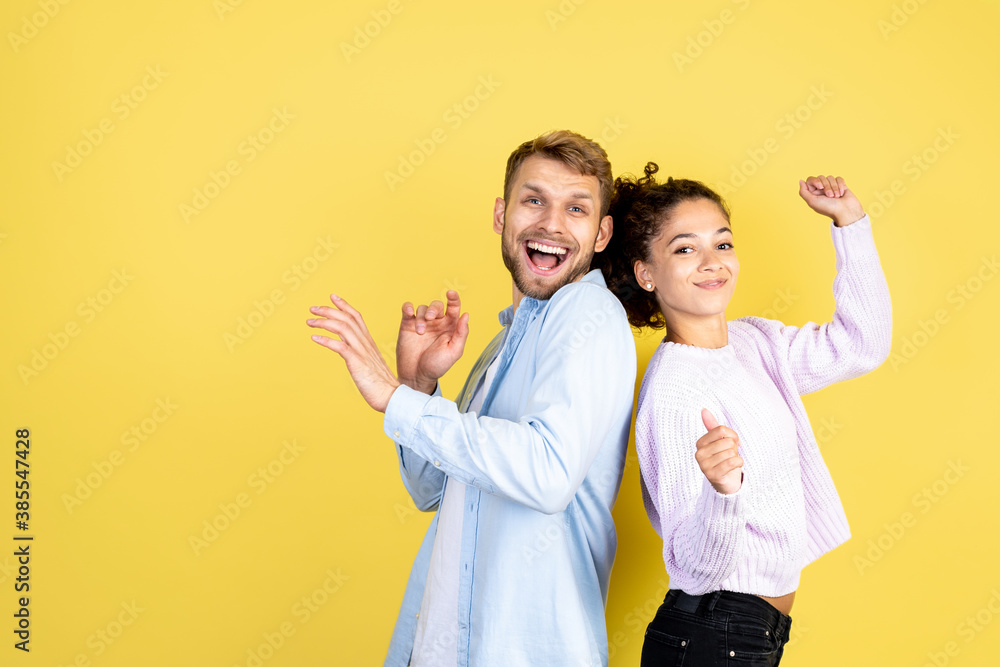Two mixed race people on yellow background