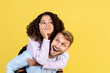 © brizmaker - Two mixed race people on yellow background