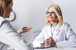 © LIGHTFIELD STUDIOS - Selective focus of doctor with clenched hands sitting near patient at workplace