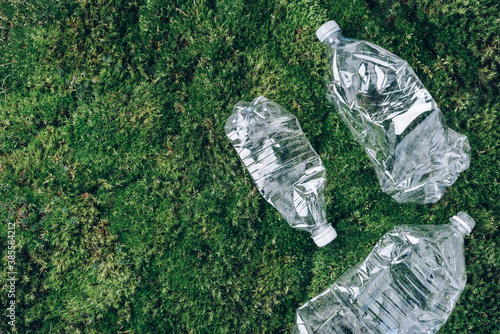 Plastic bottles on green moss background. Recycle plastic, waste pollution concept. Top view, copy space. Environmental protection concept. Reuse garbage, plastic free. Earth, world water day