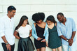 © etonastenka - group of friends laughing over something they looking at smartphone. Young people addiction to new technology trends. Concept of youth, tech, social and friendship