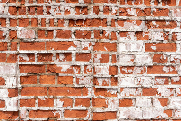 Rusty weathered red brick wall with concrete and broken parts. Old construction or weathered building. Loft or urban style of interior, background with copy space for text. Texture or effect