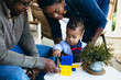 © Gerald Carter/Creative Flame - Mom and dad plays games with toddler on front porch of family home