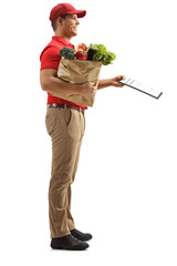 Sticker - Full length profile shot of a man delivering groceries and holding a clipboard