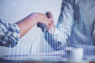 Double exposure of forex graph hologram and handshake of two men. Stock market concept.