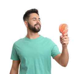 Canvas Print - Man enjoying air flow from portable fan on white background. Summer heat