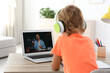 © New Africa - Little boy studying with teacher via video conference at home. Distance learning during COVID-19 pandemic