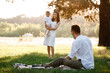 © Andriy Medvediuk - father, mother and son blow soap bubbles in the park together on a sunny summer day. happy family having fun outdoor