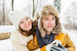 © karepa - happy loving couple walking in snowy winter forest, spending christmas vacation together. Outdoor seasonal activities