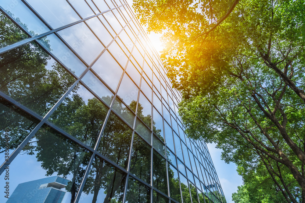 modern office building with green trees. Stock Photo | Adobe Stock