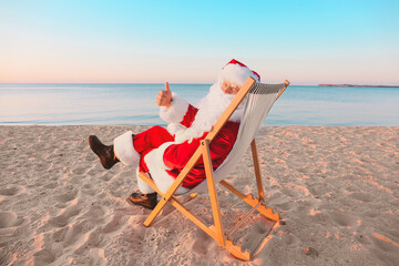 Santa Claus resting at sea resort. Christmas vacation