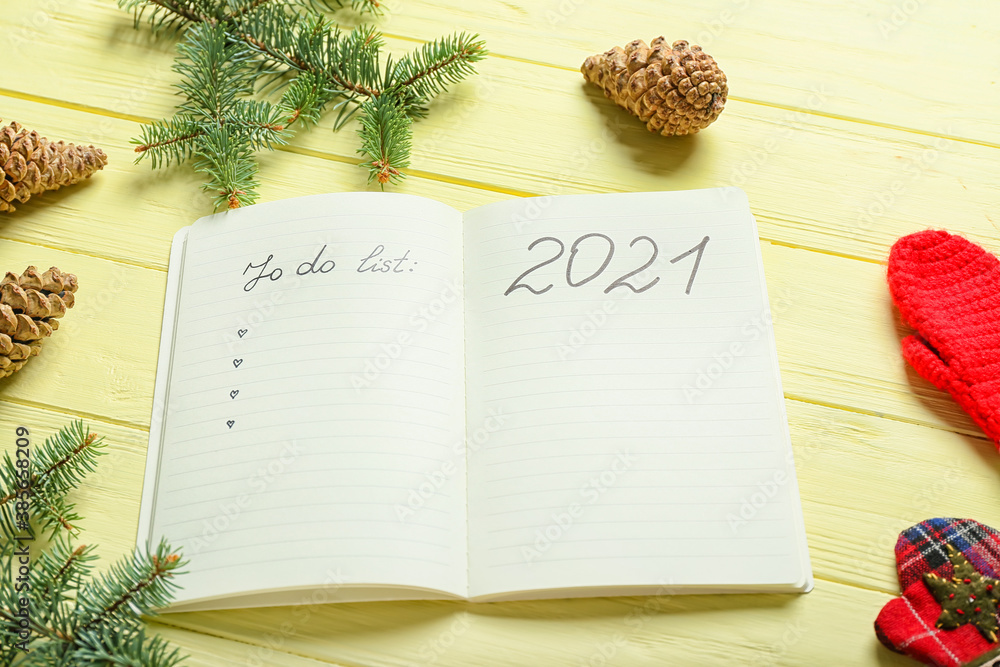 Notebook with blank to-do list for year 2021 on wooden background
