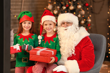 Santa with cute elf kids at home on Christmas eve