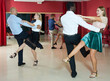 © JackF - Couples of young people practicing vigorous jive movements together at modern dance studio