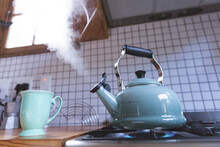 Close Up Of Kettle On Gas Burner In Kitchen