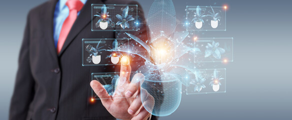 Fototapete - Man holding and touching holographic projection of a plant with digital analysis 3D rendering