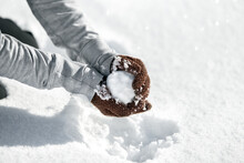 Woman Forming A Snowball For A Funny Fight, Winter Game In The Snow