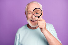 Close-up Portrait Of Cheerful Grey Beard Hair Pensioner Investigator Watching Through Loup Isolated Over Purple Background