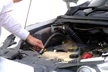 Man checking the car engine and master repairs under the hood of the car, and car insurance concept 