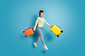 Poster - Full length body size photo of jumping cheerful girl keeping colorful bags before holidays isolated on bright blue color background