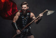 © Fxquadro - Aggressive combat rome warrior with beard in black armor screaming holding his two handed axe in dark background.