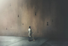 Illustration On Man Holding Big Key In Front Of Many Different Keyholes, Surreal Concept