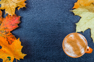 cup of coffee cappuccino with cinnamon on a dark background with maple leaves with a copy of the spa