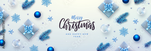 Merry Christmas and Happy New Year greeting card. Top view Christmas holiday background with fir tree, snowflakes, glass balls, gift boxes and stars