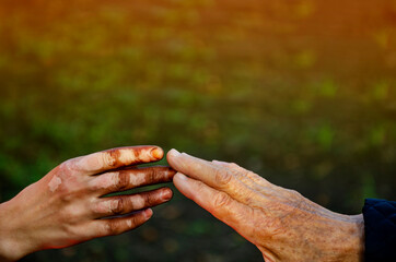 The pigment hand touches the old hand. Skin problems. The concept of friendship with people of different nationalities. discrimination based on nationality and ethnicity. The power of friendship