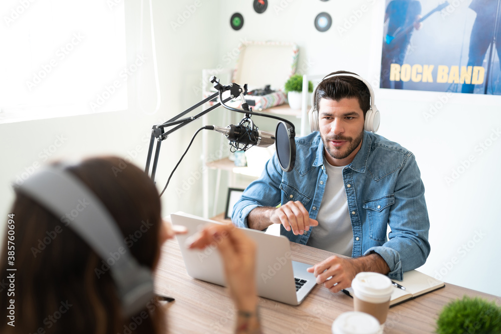 Radio host conducting interview of guest Stock Photo | Adobe Stock