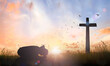 Good Friday concept: Silhouette of prayer woman bow down and praying over cross on sunset background