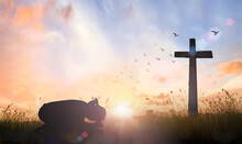 Good Friday Concept: Silhouette Of Prayer Woman Bow Down And Praying Over Cross On Sunset Background
