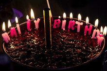Chocolate Birthday Cake With Lit Happy Birthday Candles
