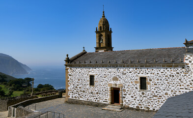 Wall Mural - View of sanctuary in the village of San Andres de Teixido, overlooking the ocean in the Galicia region of Spain.