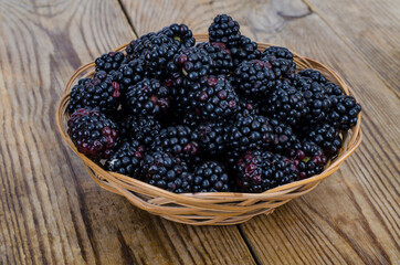 Wall Mural - Ripe sweet black blackberries in wooden bowl